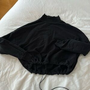 Cropped, black, turtleneck sweatshirt with adjustable drawstring